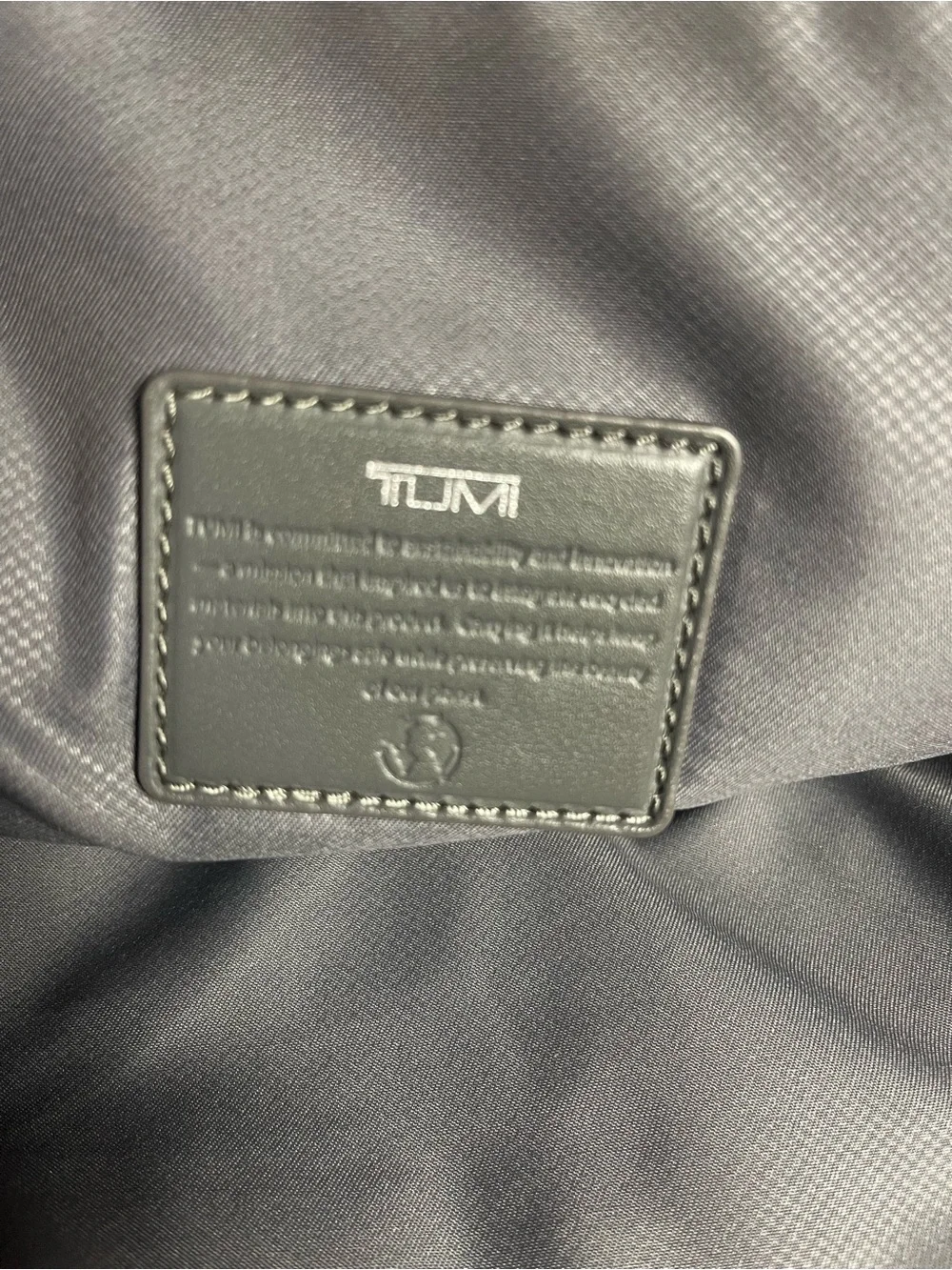 Tumi Voyageur Halsey nylon Gray Backpack with leather Top Handles.